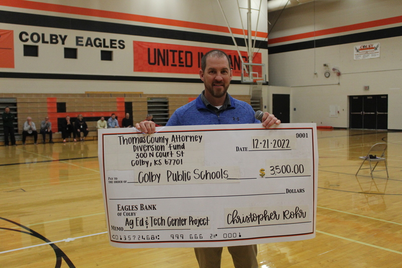 CHS Principal, Ryan Muhlig, accepts a check from the Thomas County Diversion Fund